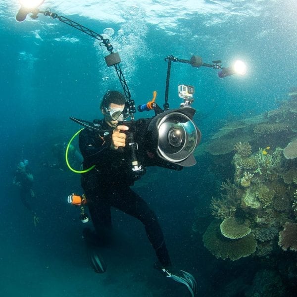 A film still from Chasing Coral showing Director Jeff Orlowski filming on the Great Barrier Reef.
