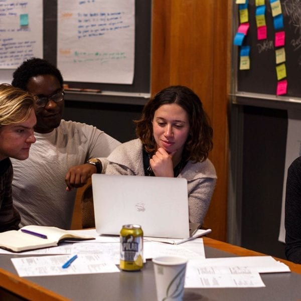 Students collaborating with a local entrepreneur to refine their ideas.