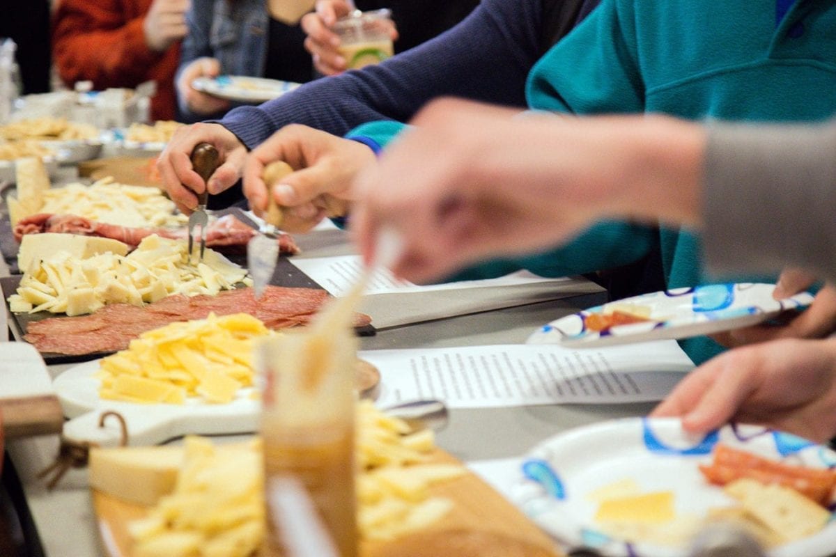 Students trying the different cheeses and meats