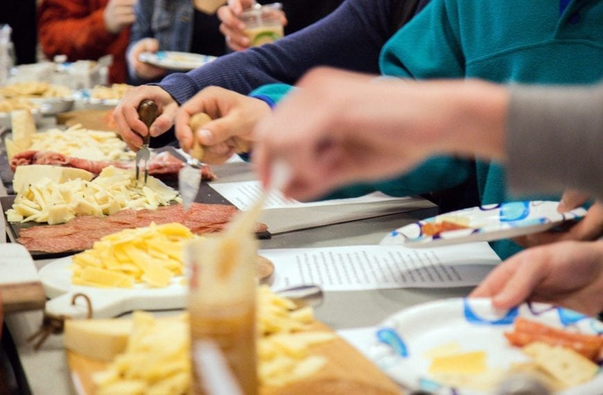 Students trying the different cheeses and meats