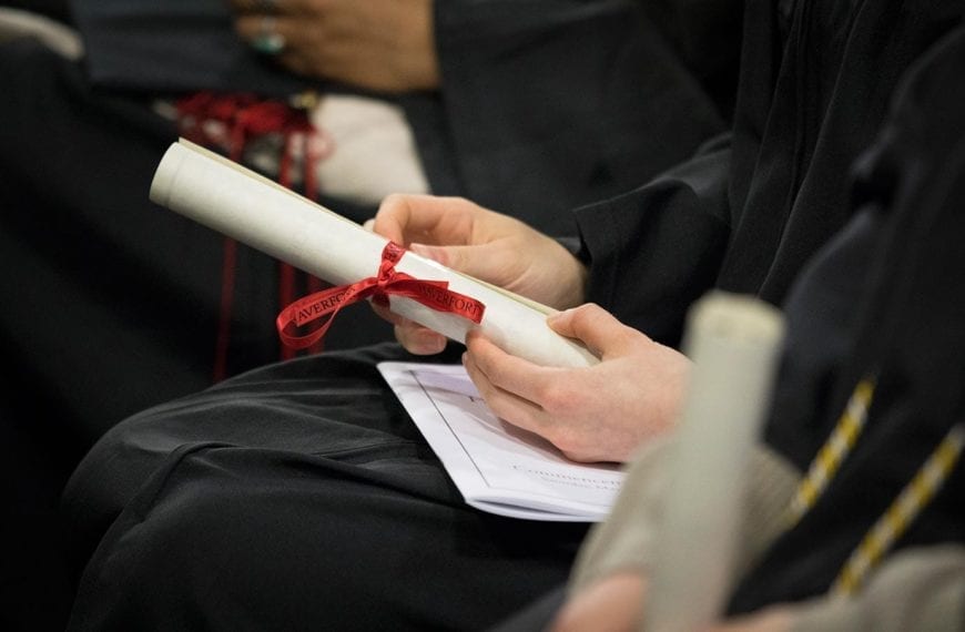 Student's hands holding a diploma