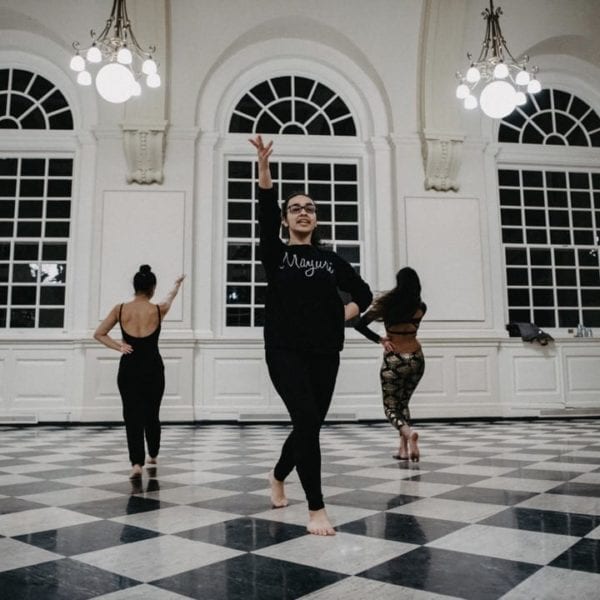 The South Asian fusion dance group practices in Founders Great Hall