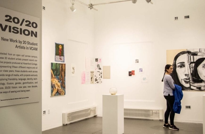 A glimpse into the gallery with artwork on the wall and on a pedestal