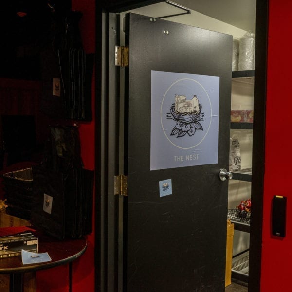 Black door open with the blue nest logo on it