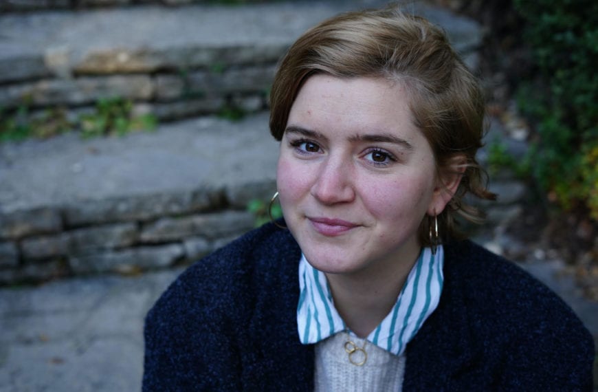 Becca Richie sits on steps