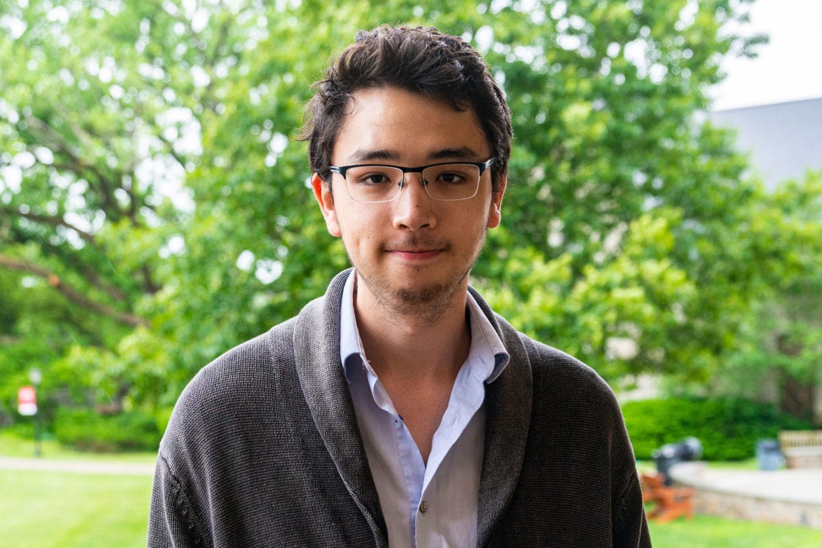 Headshot of Jonathan Sudo in front of trees.