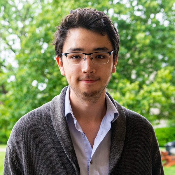 Headshot of Jonathan Sudo in front of trees.
