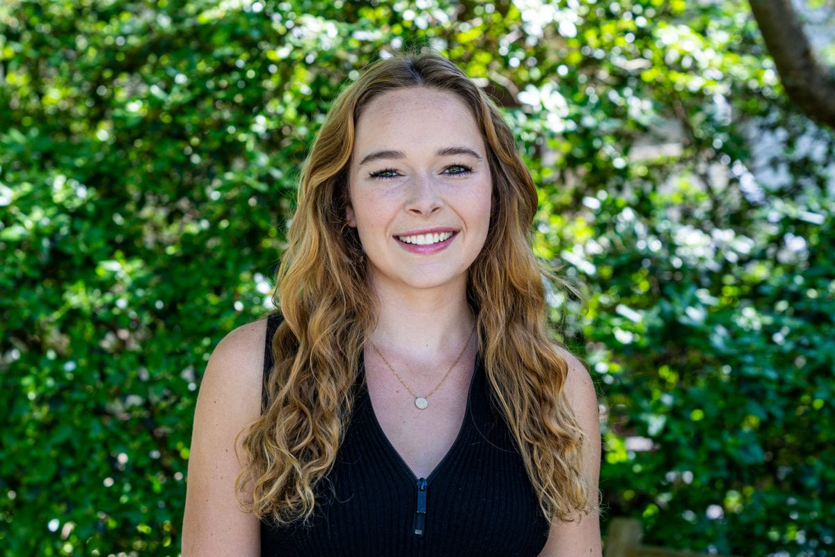 Headshot of Claire Nicholas '21 in front of greenery