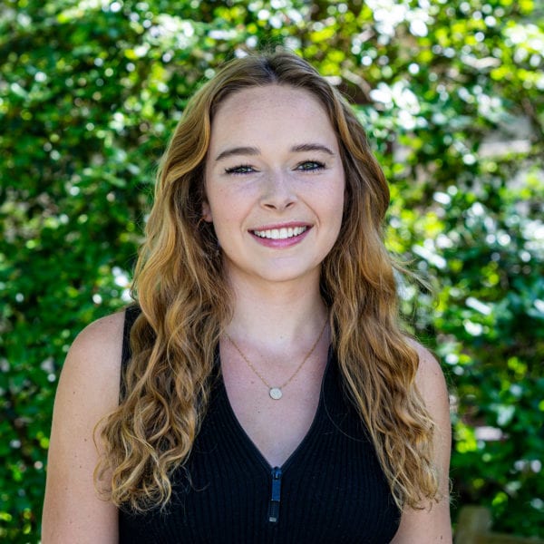 Headshot of Claire Nicholas '21 in front of greenery