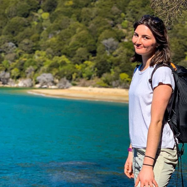 A photo of Chace in athletic clothes in front of the ocean.