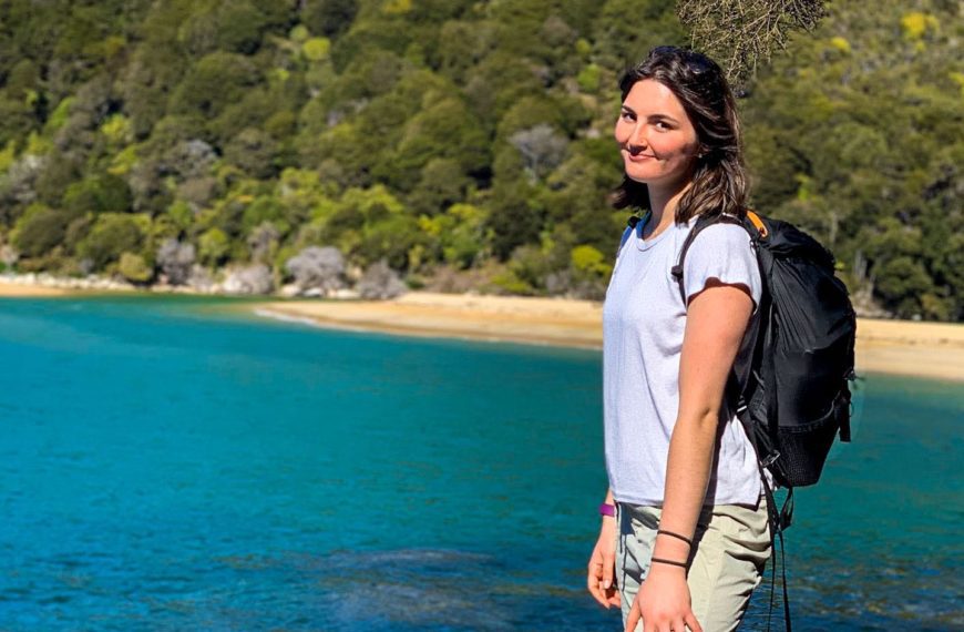 A photo of Chace in athletic clothes in front of the ocean.