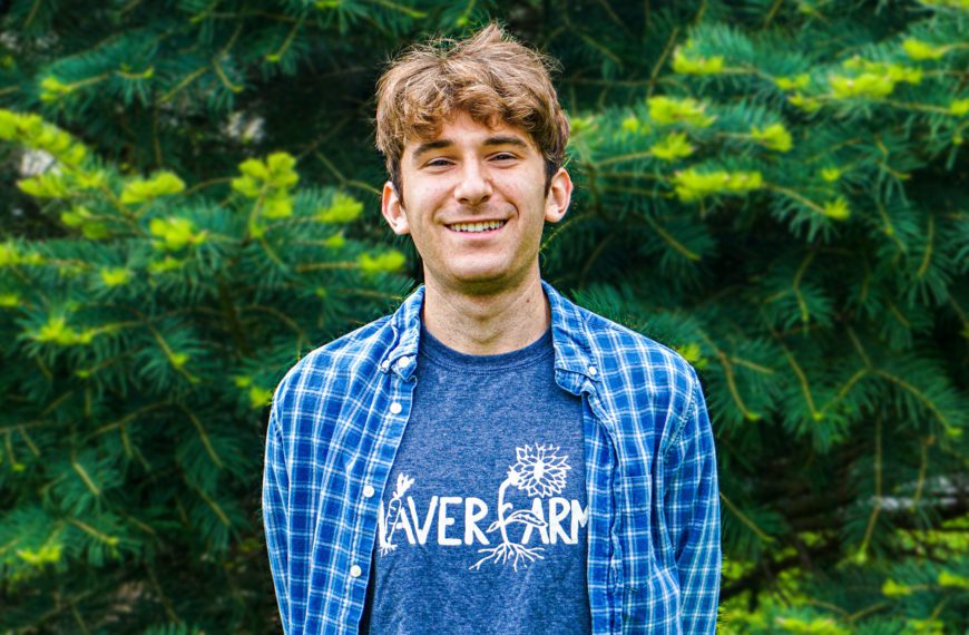 A photo of Jacob in front of a tree, wearing a blue Haverfarm shirt.