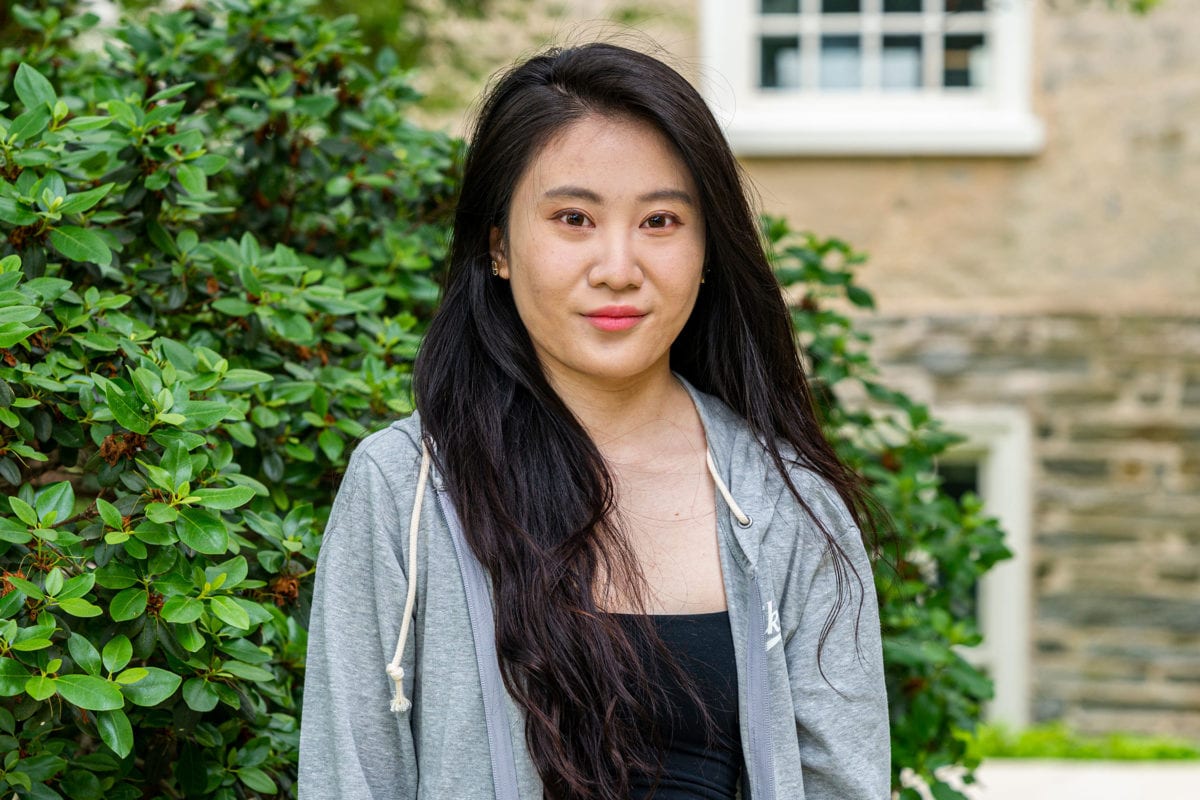 Headshot of Anqi standing to the side of Founders Hall.