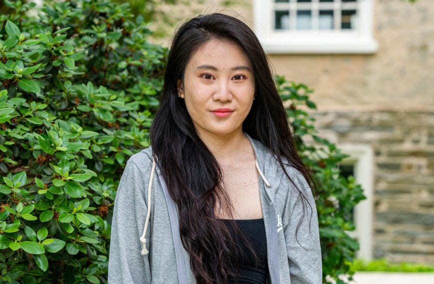 Headshot of Anqi standing to the side of Founders Hall.