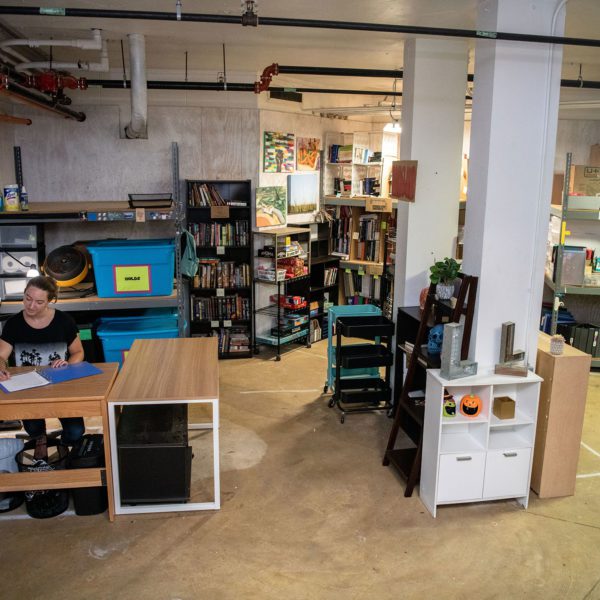 Arboretum Program Coordinator Jennie Ciborowski sits in the corner of the (RE)Use Store, surrounded by books and mini-fridges