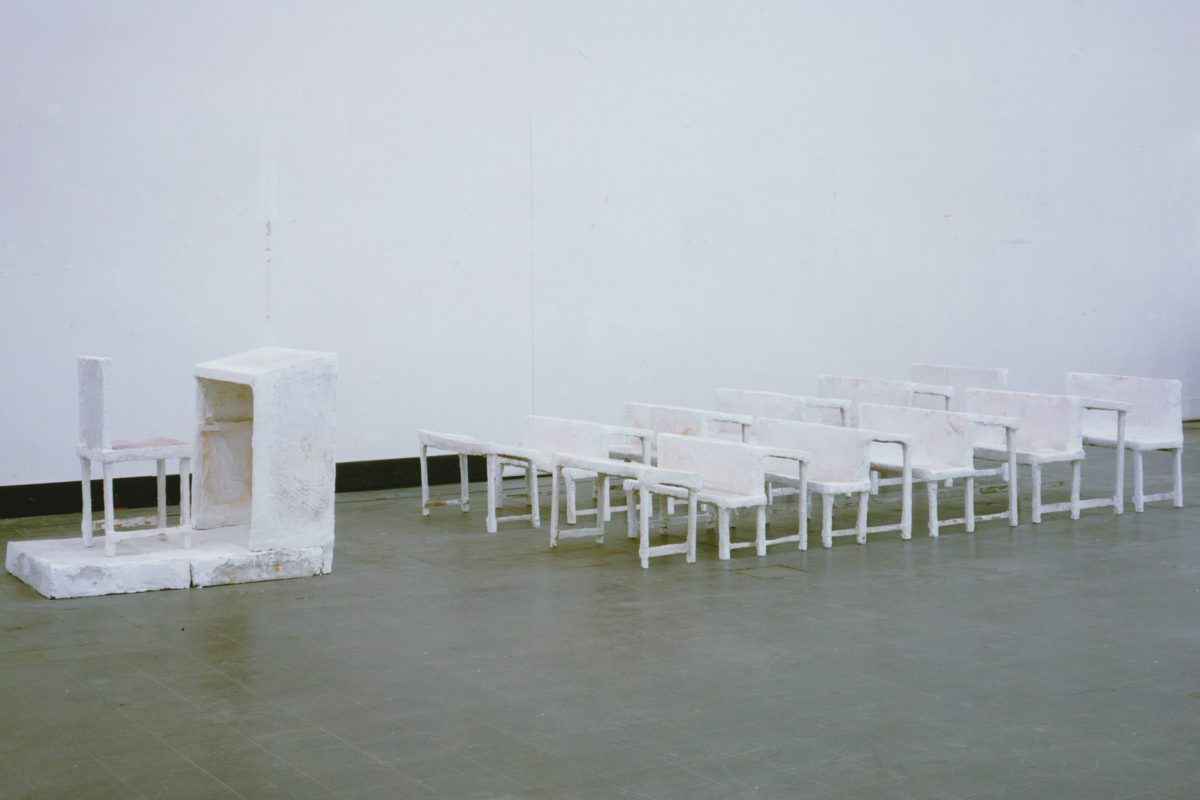 Inge Mahn's sculpture "Schulklasse," which shows white rows of seating in front of a white teacher's podium