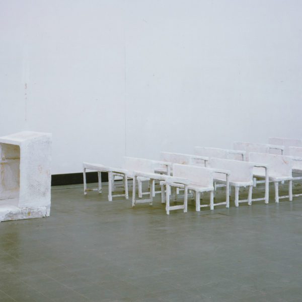Inge Mahn's sculpture "Schulklasse," which shows white rows of seating in front of a white teacher's podium