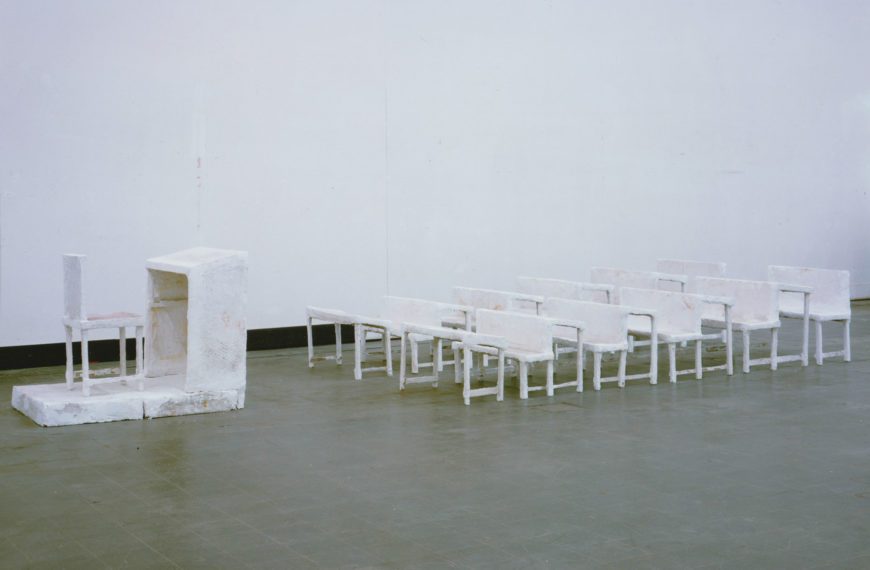 Inge Mahn's sculpture "Schulklasse," which shows white rows of seating in front of a white teacher's podium