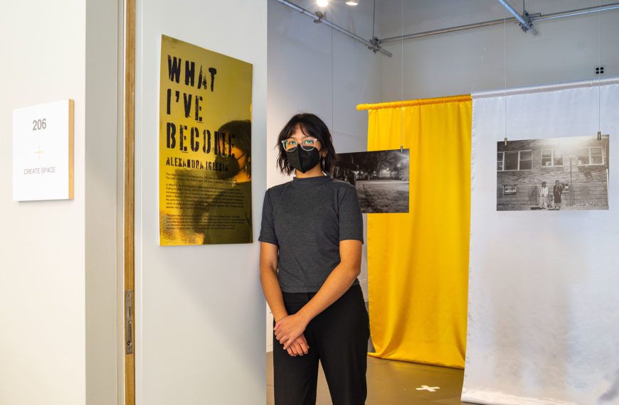 Lexie Iglesia '21 at the entrance of their exhibition, "What I've Become."