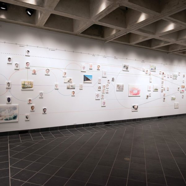 A massive, multi-wall installation of intersecting timelines and portraits showing the political lines of the country from the past into the future.