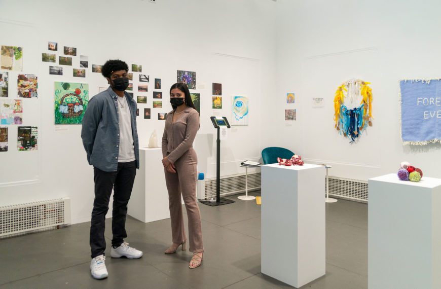Jalen Martin '23 and Izzy Ray '23 stand in their exhibition, The Art of Healing: Heart & Home.