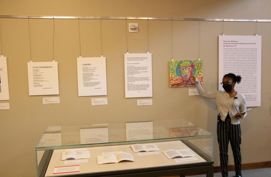 Taliyah Evans explains poetry on the exhibit wall.