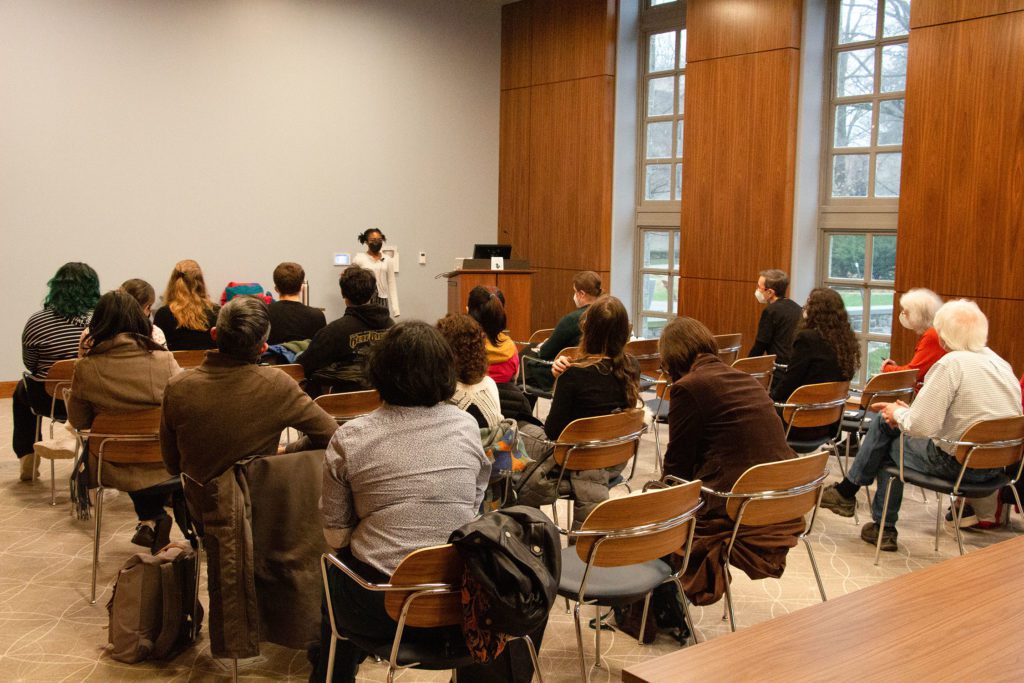Taliyah Evans '24 speaking about her exhibit to an audience of around 20.