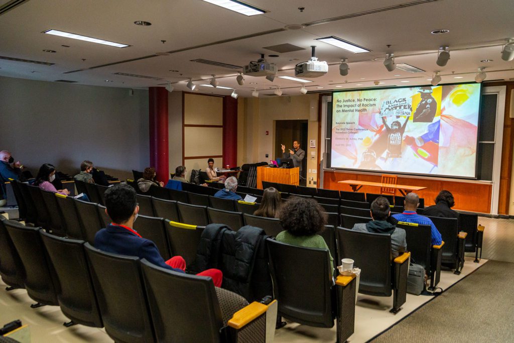 Conference attendees watch as Dean John McKnight introduces Dr. Kimberly Ashby, keynote speaker.