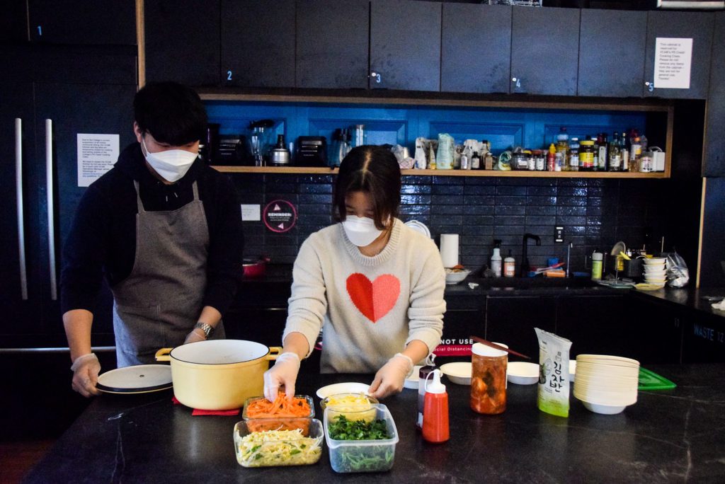 Yehyun Song '25 and Heewon Park '25 prepare bibimbap