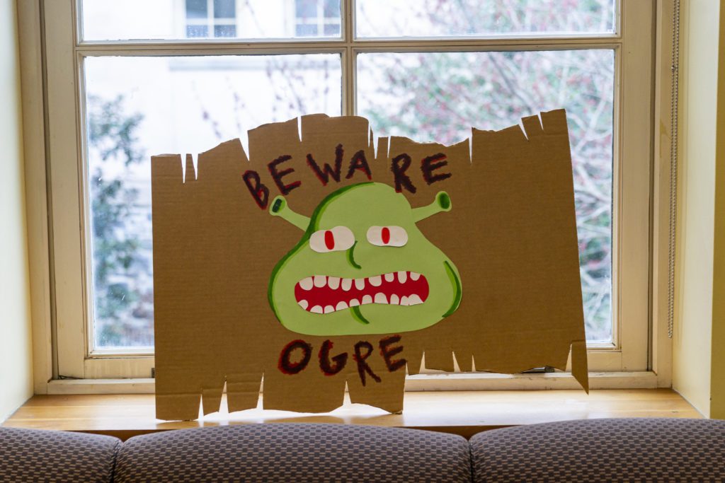 A sign saying "Beware the Ogre" with a picture of Shrek's face in Zubrow Commons.