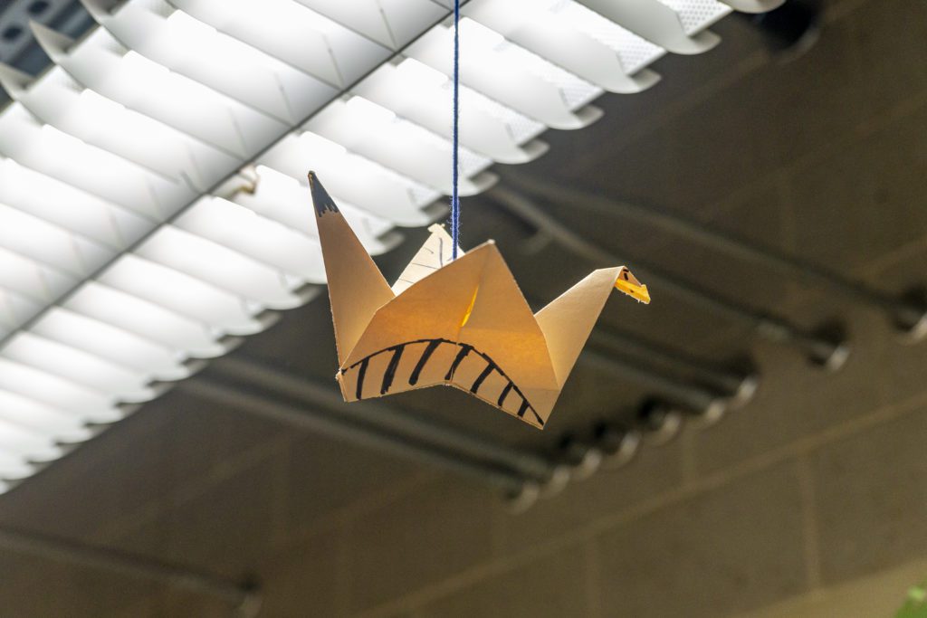 A paper crane hanging from the ceiling.