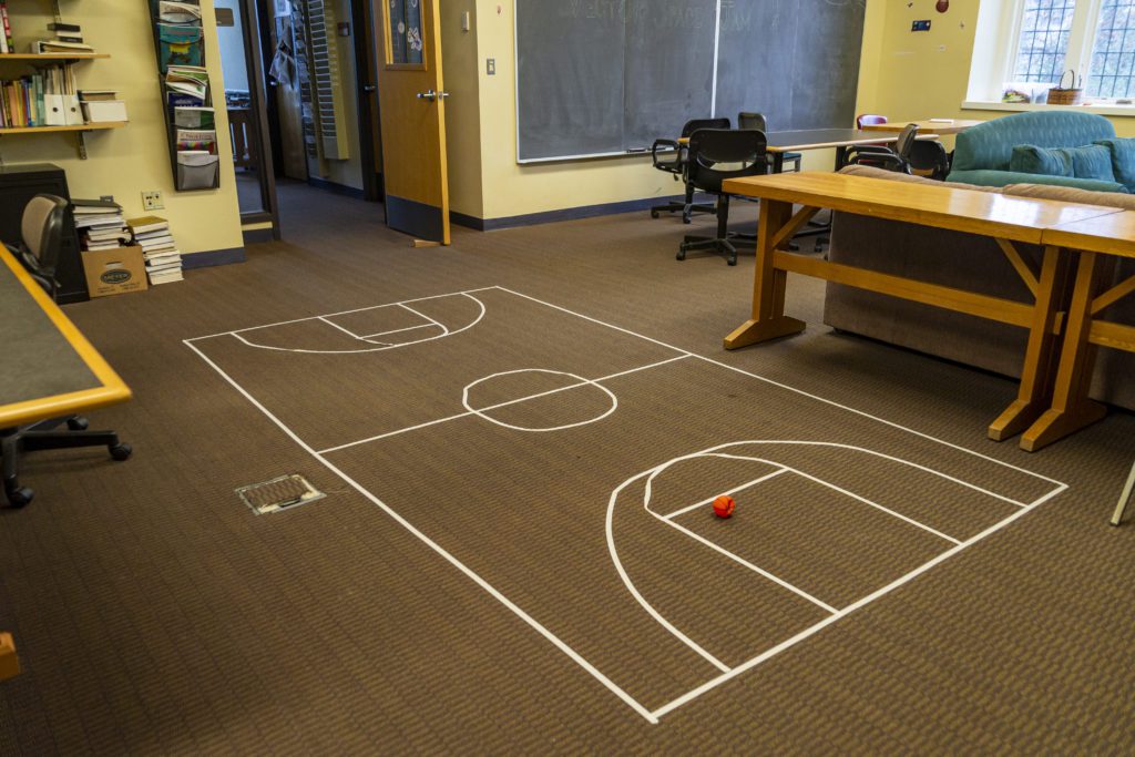 A basketball court taped out on the rug of the Math Lounge.