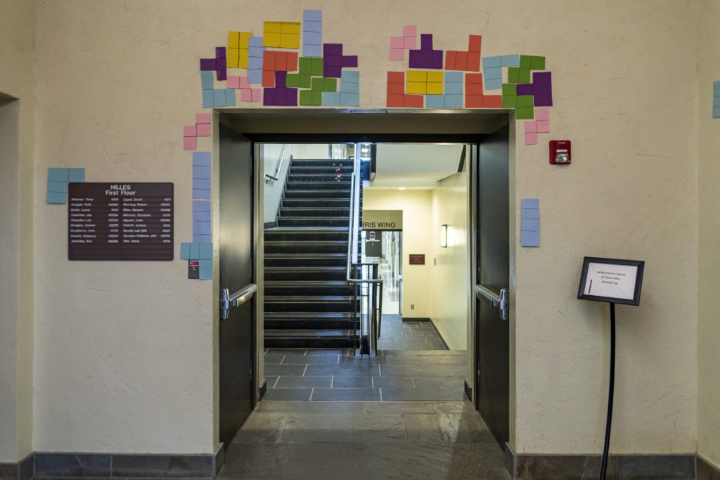 Construction paper Tetris pieces hang over an archway in Hilles Hall.