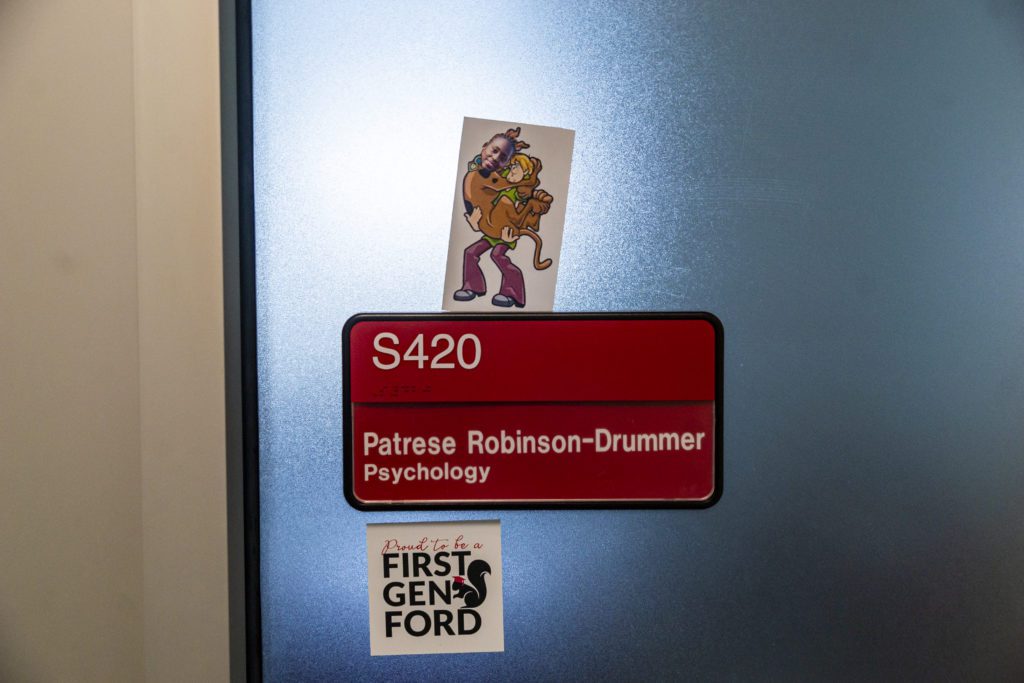 Patrese Robinson-Drummer's head superimposed on Scooby Doo's body as he jumps into Shaggy's arms on her office door.