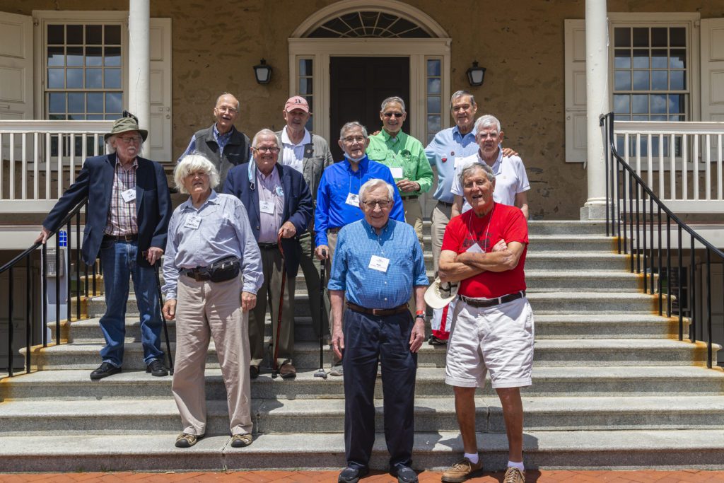 11 men from the Class of 1962 stand on the steps of Founders for a portrait.