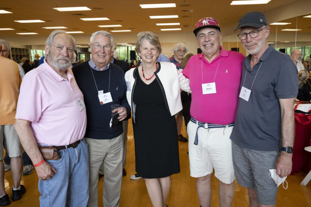 President Wendy Raymond poses with four alumni