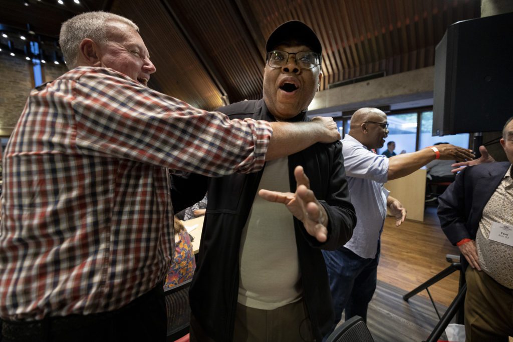 A friend surprises another with a hug inside the DC.