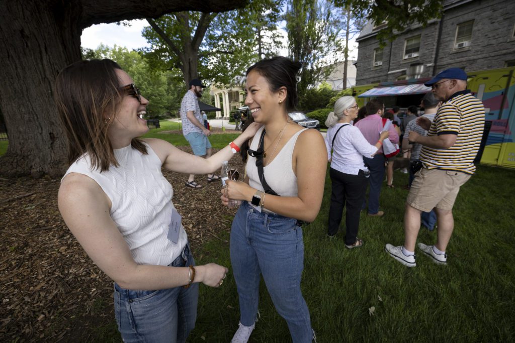 Friends catch up while waiting in line for food trucks.