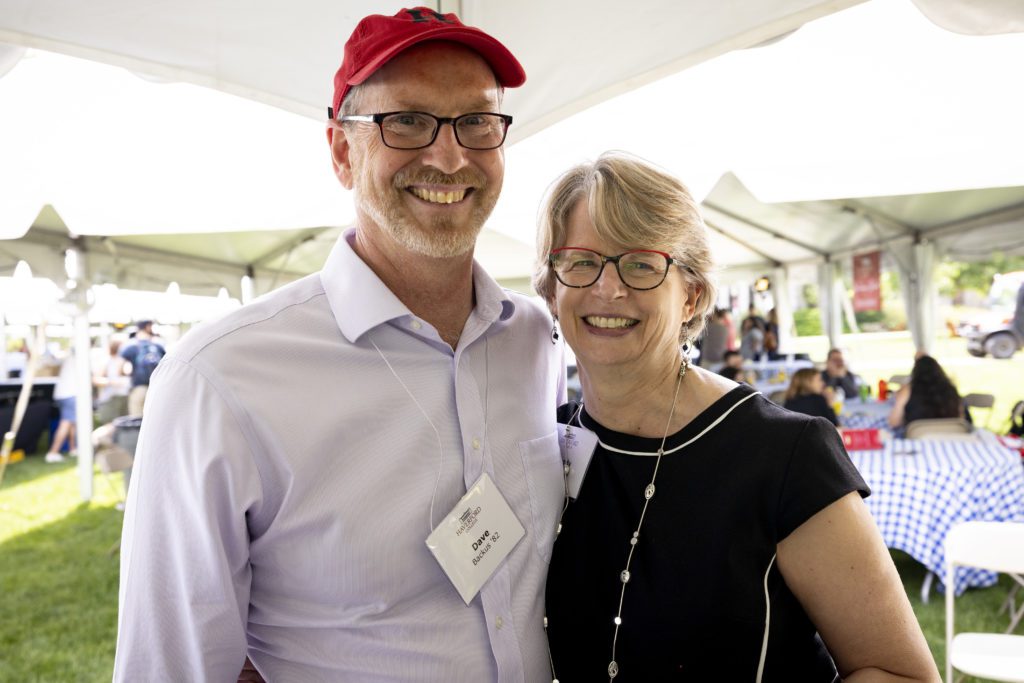 Wendy and Dave smile under the tent on a sunny morning.