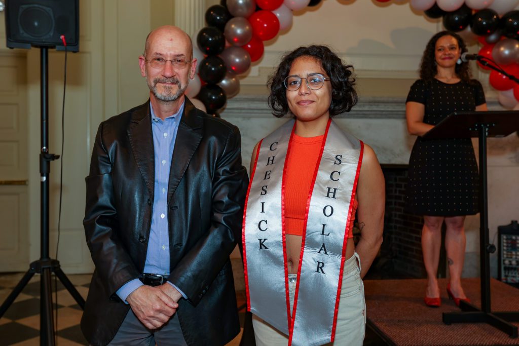 Zarahy Rivas poses next to Jeff Tecosky-Feldman after receiving the Chesick Scholar sash