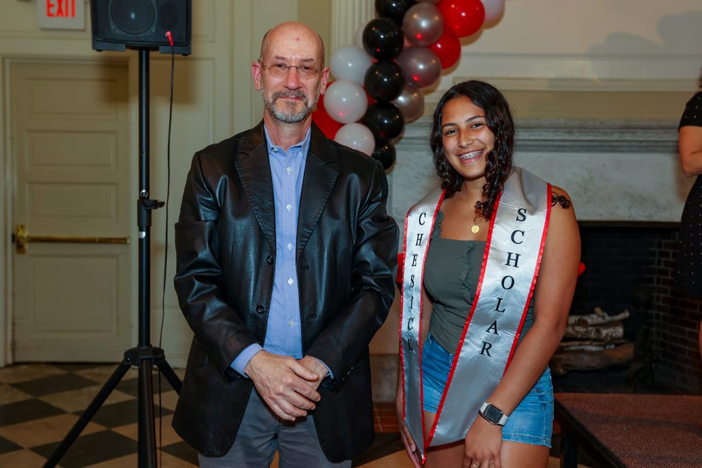 Keishla Sanchez poses with Jeff Tecosky-Feldman after receiving her Chesick Scholar sash.