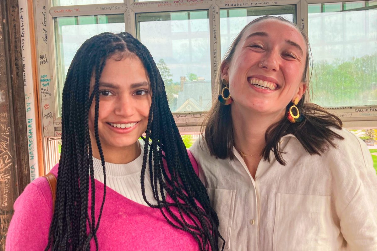 Zoe and Lizy are smiling next to a window