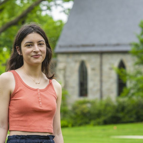 Çiçek Yavuz ‘22 stands on Founder's Green, smiling.