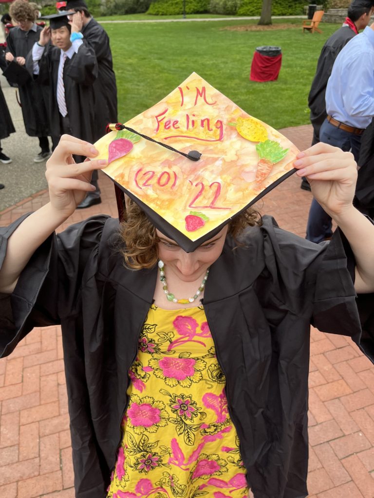 A graduate shows off cap decorations that say "I'm feeling (20)22"