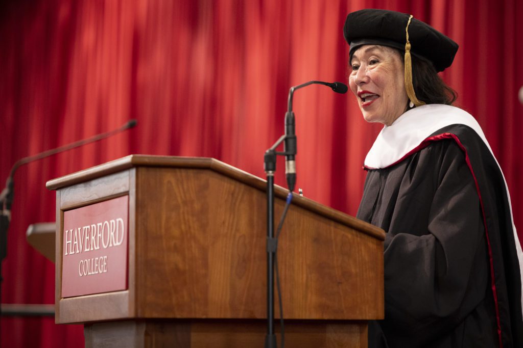 Dr. Korematsu speaks into a microphone at a Haverford College podium.