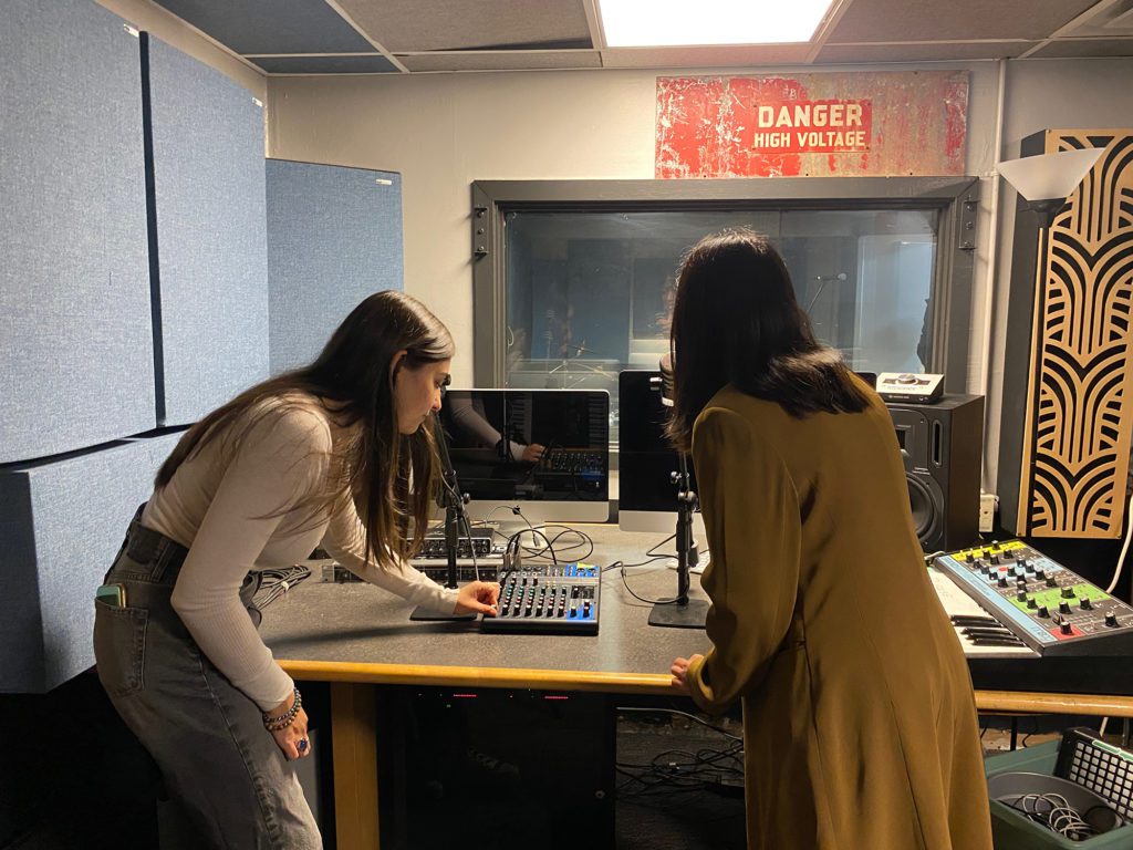 Sarah Mastrocola '23 and Natalie White '23 show some of the equipment in Haverford's radio control room.