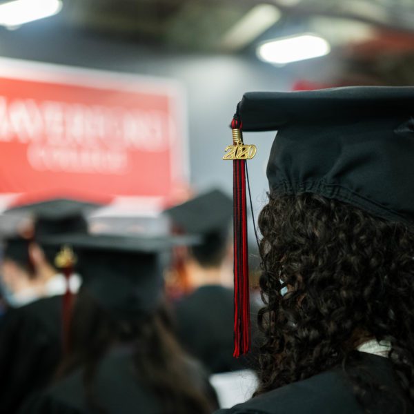 A closeup of the 2020 on a graduates tassel with the Haverford College banner blurry in the baackground.