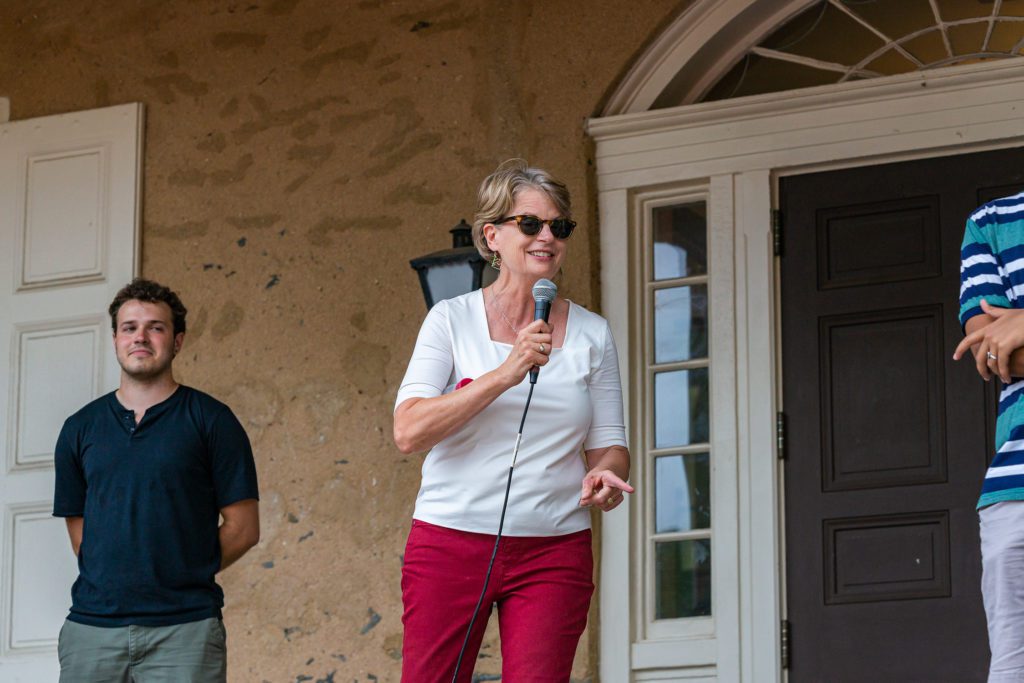 President Raymond in front of Founders on the microphone.
