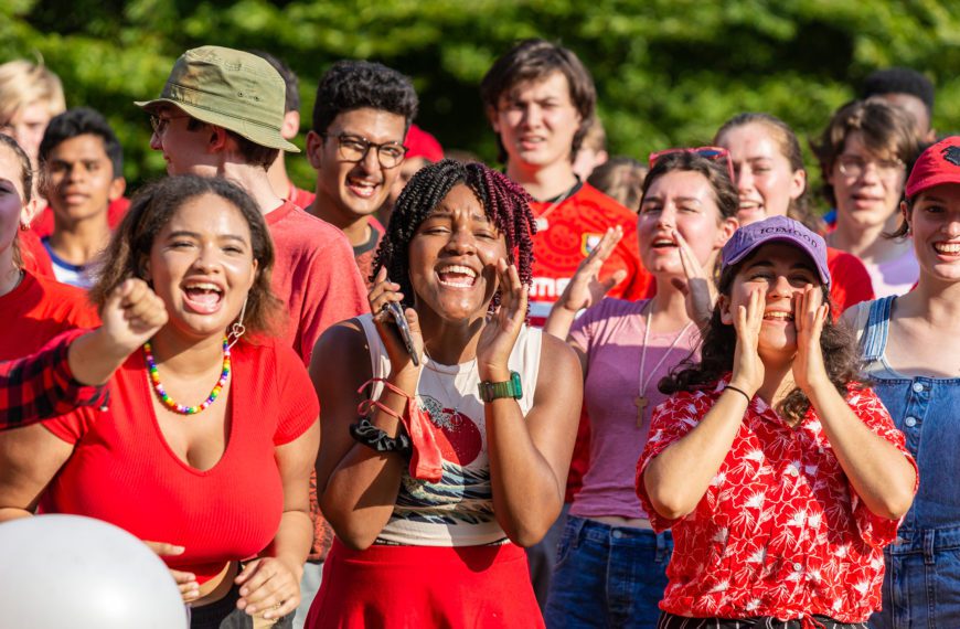 Students dressed in red cheer and clap