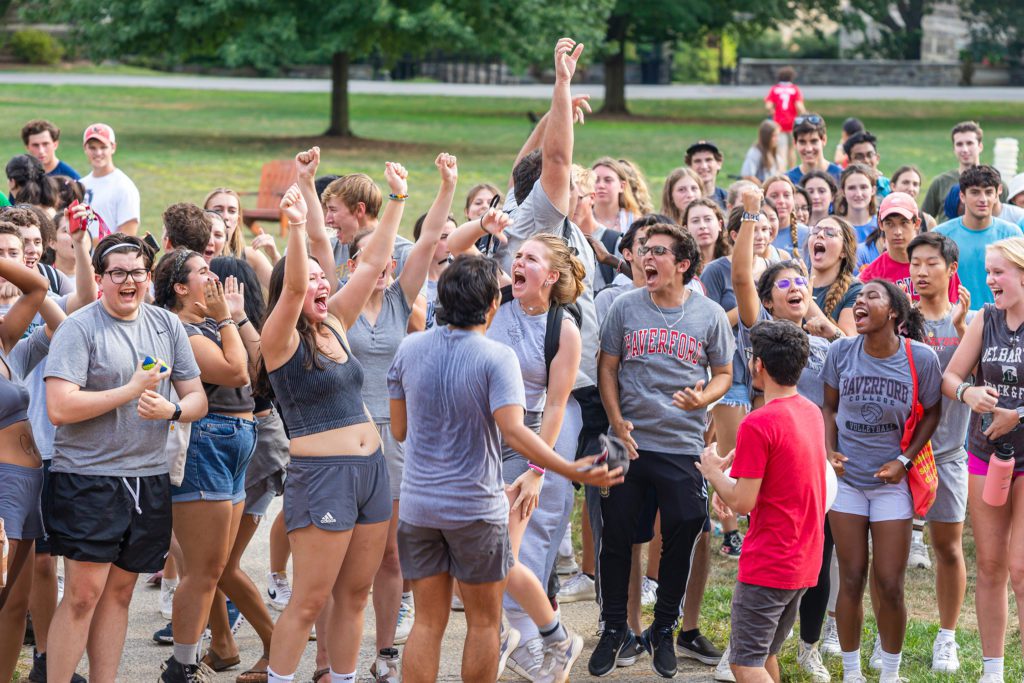 The gray Gummere team cheering with their arms in the air.